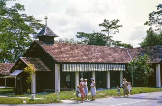 European women and children outside Christian chapel or church, from a series about Singapore and