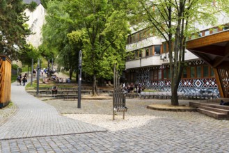 Small park with seating, a playground and a fountain at the entrance to Trencin Castle, Capital of