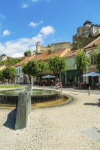 Mark Aurel fountain and fountain on Peace Square with Trencin Castle in the background, Capital of