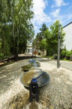 Small park with seating, a playground and a fountain at the entrance to Trencin Castle, Capital of