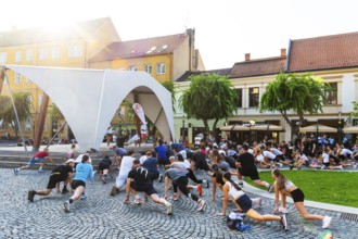 An event by a local fitness centre takes place on a stage on Peace Square, Capital of Culture 2026,