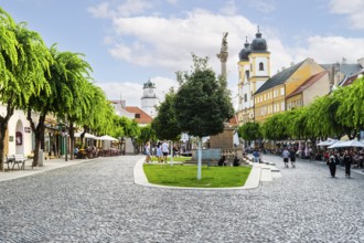 Peace Square with cafés in the old town of Trencin, in the background the Piarist Church of St