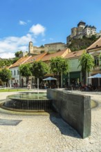 Mark Aurel fountain and fountain on Peace Square with Trencin Bridge in the background, Capital of