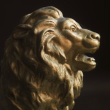 A lion head sculpture stands out with its detailed mane and expressive features. It captures the