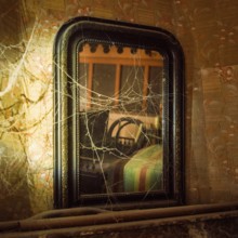 A weathered mirror stands in a neglected room, covered in cobwebs. The faded decor hints at past