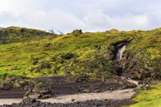 Barren moss-covered volcanic landscape, stream, Arnarstapi, Snaefellsjökull volcanic system,