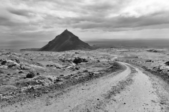 Barren mossy volcanic landscape, cone-shaped mountain Stapafell, monochrome, Arnarstapi, volcanic