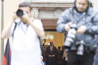Friedrich Merz (CDU, German Chancellor) waits behind photographers for Emmanuel Macron (President