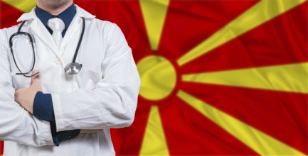 Male doctor with stethoscope on North Macedonia flag. Doctor holding stethoscope on North Macedonia