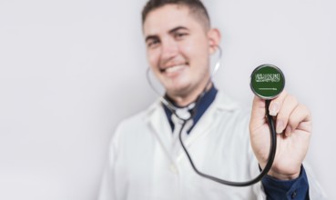 Doctor showing stethoscope with Saudi Arabia flag. Saudi Arabia national healthcare concept