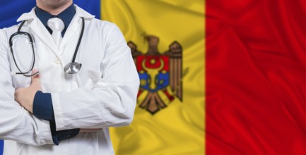 Male doctor with stethoscope on Moldova flag. Doctor holding stethoscope on Moldova flag
