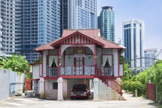 Traditional small house surrounded by modern skyscrapers, Kuala Lumpur, Malaysia, Asia