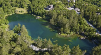 Aerial view Bird's eye view of small mountain lake Alpine lake Lago Grande near Moncenisio behind
