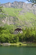 View of chalet at mountain lake Lago Grande near Moncenisio in Val Cenischia in Graian Alps,