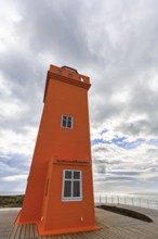 Orange lighthouse Skálasnagaviti or Svörtuloft with wooden boardwalk, Skalasnagi, Öndverdarnes,