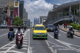 Road traffic taxi and motorbike scooter, Bangkok, Thailand