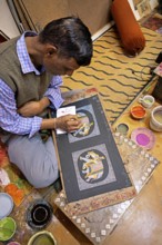 Miniature painter, 52 years old, paints an elephant picture in his studio, Udaipur, Rajasthan,