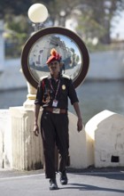 Security guard in traditional dress at the city palace, Udaipur, Rajasthan, India