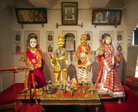 Indian traditional woman and men, dolls, worshipping Radha Krishna in the City Palace Museum, City