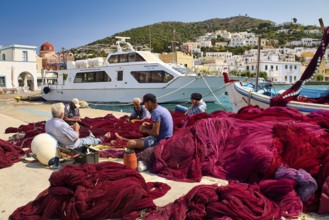 People sitting on the shore with a view of the ships in the Mediterranean, Agia Marina, Leros,
