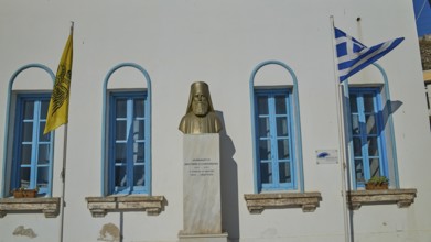 Archimandrite, Anastaios N. Zafeiropoulos, memorial bust between Greek and ecclesiastical flag in