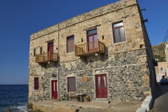 Two-storey stone house with red windows right by the sea, rustic charm, Agia Marina, Leros,