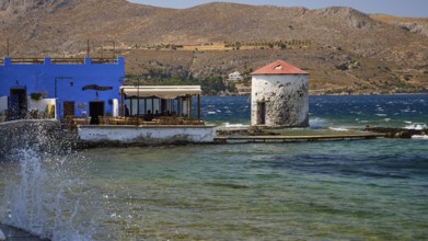 Restaurant Mylos, coastline with a windmill and a blue building by the sea, Agia Marina, Leros,
