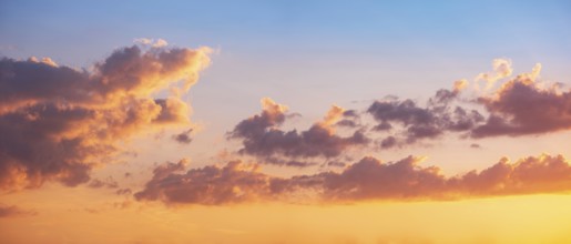 Wallpaper for sky replacement, evening sky with orange glowing clouds at sunset
