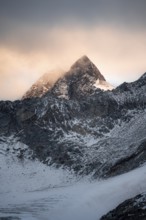 Cloudy atmosphere at sunset, rocky summit Wilder Pfaff, Stubai Alps, South Tyrol, Italy