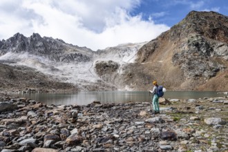 Mountaineer in front of mountain landscape with limestone rocks between granite mountains, mountain
