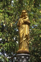 Gilded statue of the Virgin Mary with the infant Jesus, in front of St Briccius Church, Lindenstr.2