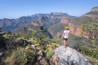 Hiker enjoying panorama, Blyde River Canyon with summit Three Rondawels, view of canyon with river