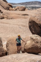 Tourist with camera, rock formation, Pontok Mountains, Spitzkoppe, Große Spitzkuppe Nature Reserve,