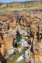 Eroded rock formations, canyon with steep orange-coloured rock cliffs with the Blyde River,