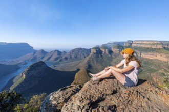 Hiker enjoying panorama, Blyde River Canyon with summit Three Rondawels, view of canyon with river