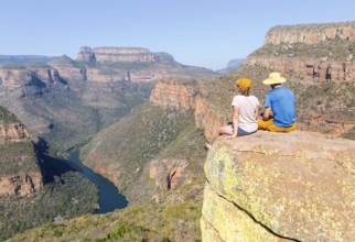 Two hikers enjoying panorama, Blyde River Canyon with Three Rondawels peak, view of gorge with