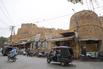 Street scene in the old town of Jaisalmer, the fortress in the background, Rajasthan, India