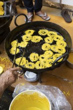 Indian man frying local sweet in the old town of Jaisalmer, Rajasthan, India