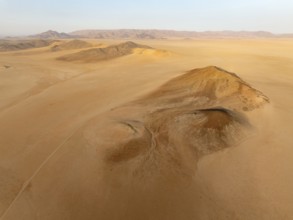 Arid plains, and bare mountain ridges in the Tsondab Valley in the Namib Desert. Aerial view. Drone