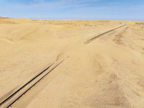 Rails covered with sand in the southern Namib Desert. Aerial view. Drone shot. Namibia
