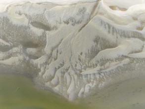 Low tide patterns and Greater Flamingos (Phoenicopterus ruber) at the Walvis Bay Lagoon. Aerial