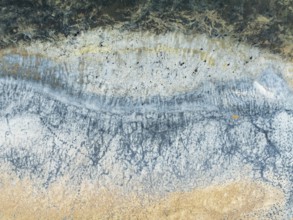 Abstract saline patterns at the edge of the Walvis Bay salt works. Aerial view. Drone shot. Namibia