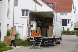 Relocation symbolic image: lorry being unloaded in front of a residential building
