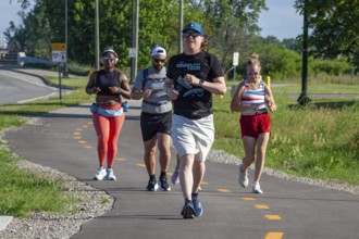 Detroit, Michigan - Runners on a trail that circles Belle Isle, a state park in the Detroit River