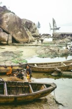 Cleaning the hull of a boat with flames from a small fire in a process known as breaming, Castle