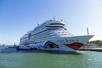 Cruise ship AIDA nova is pushed against the quay wall by tugboats, Warnow, Warnemünde, Rostock,