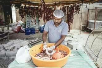 Traditional camel restaurant in Salalah, stuffing camel sausages, Dhofar, Oman