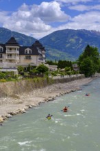 Kayakers in the river in front of the Grandhotel Lienz on the Isel, Lienz, East Tyrol, Austria