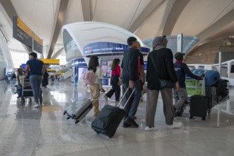 Airport people with luggage, Abu Dhabi, United Arab Emirates