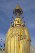 32 metre high standing Buddha decorated with glass mosaics and 24 carat gold, the upper knot of the